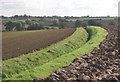 Footpath by ditch across open fields