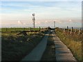 Hill farm track and comms mast above Brynna