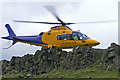 Air ambulance coming in to land at Windgather Rocks