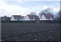 Ploughed field and houses on The Street, Chattisham