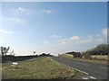 The A 4080 topping the ridge above Llanfaelog