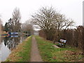 Canal towpath with bench and milepost