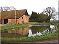 Barn reflecting in farm pond