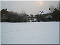 Looking from a snowy Church Field towards Huntley Close