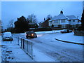 Junction of a snowy Sixth Avenue and Medina Road