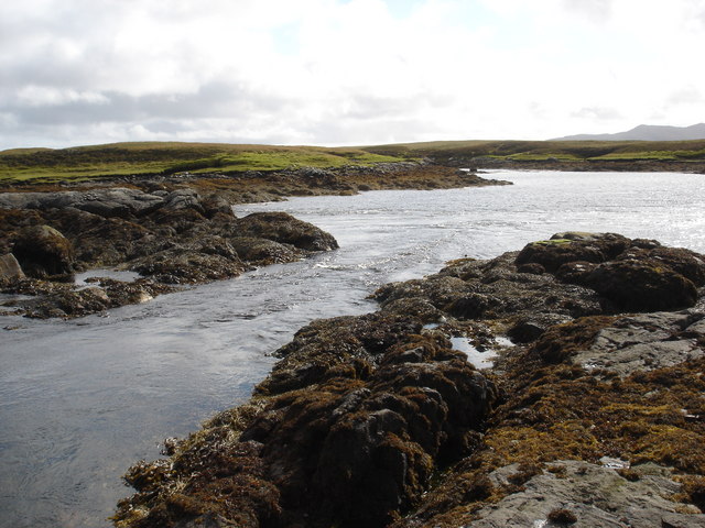 Tidal rapid draining Loch Dheoir Behind Lochmaddy is an area of shallow lagoons filled and drained by the tides each day. Where the tide runs between the rocks, tidal rapids are formed like this one in a narrows which drains Loch Dheoir towards Loch Blathaisbhal during the ebb.