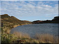 A mine pool below the waste tips of the Mona Mine