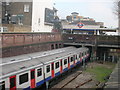 District Line Trains arriving and departing at West Kensington Underground Station