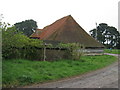SU9716 : Steep roofed barn at Barlavington Farm by Dave Spicer
