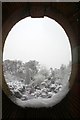 Golders Hill Park formal garden through a hole in the wall