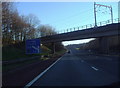 Railway bridge over M6 motorway and motorway sign.