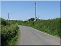 Unclassified road, farm machinery & roof-line of Llwynmendy Uchaf