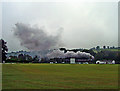 Steam train passing Bronwydd cricket field