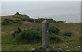 SH2990 : Coastal path waymark and cliff top cairn by Eric Jones