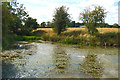 SP5060 : Pond with Park Farm in the distance by Andy F