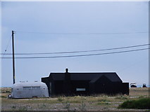 TR0917 : Black rubber cottage, Dungeness by Chris Whippet