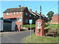 Houses in Clyst Honiton, next to the church noticeboard