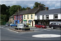 T2895 : Shops by the roundabout on Main Street, Rath Naoi by Simon Mortimer