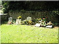 SP4535 : Graves in the churchyard at St John the Evangelist, Milton by Basher Eyre