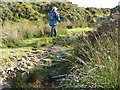 Walking on the moor up a wet track