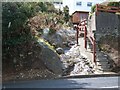 A hill-side rill disappearing beneath the A2 Kilkeel Road