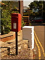 SY3392 : Lyme Regis: postbox № DT7 34, Pound Road and glimpse of Golden Cap by Chris Downer