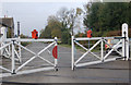 TL0997 : Level crossing gates closing, Wansford station by Andy F