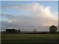 Redhouse Farm riding school and distant shower cloud