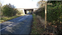 SP0473 : Footpath sign and motorway bridge. by Mike Dodman