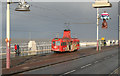 Red tram, grey seas