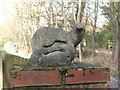 Concrete otter on gatepost