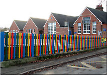 TM1686 : Colourful fence surrounding Tivetshall Primary School by Evelyn Simak