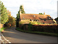 Bramerton Road past barn conversion by Church Farm