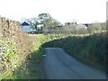 Road dips before Landulph Cross