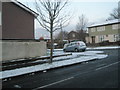 Approaching the top junction of a snowy Walford Road, looking into Ludlow Road