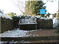 Snowy seat at the top of the steps leading to All Saints, Witley