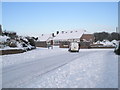 Van turning from a snowy Littlepark Avenue into Ashwood Close