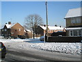 Approaching the junction of  a snowy Park House Farm Way and Hordle Road