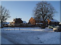 Approaching the junction of  a snowy Bransgore Avenue and Hinton Close