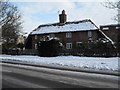 Snow on the roof of a thatched cottage in Berkeley Square