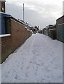 Looking along the access road for garages in Court Lane towards The Manor House