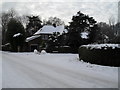 Approaching the junction of a snowy Wade Court Road and South Close