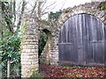 Footpath through an arch, near Croydon Hall