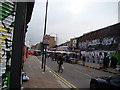 View of the market stalls and East London Line viaduct on Sclater Street