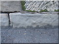 Weathered bench mark on bridge over River Alyn