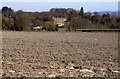 Looking over a ploughed field to Ardington House