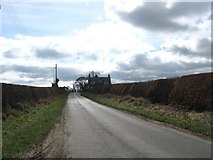 NT7032 : Minor road heading for cottages at Roxburgh Barns by James Denham