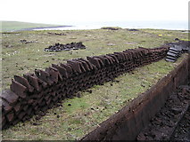 HU5766 : Peats and peat bank near Vaivoe, Whalsay by Robbie