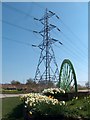 Pit-head wheel and daffodils with pylon at eastern edge of Treeton village