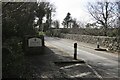 Lydford Village sign by the old railway bridge